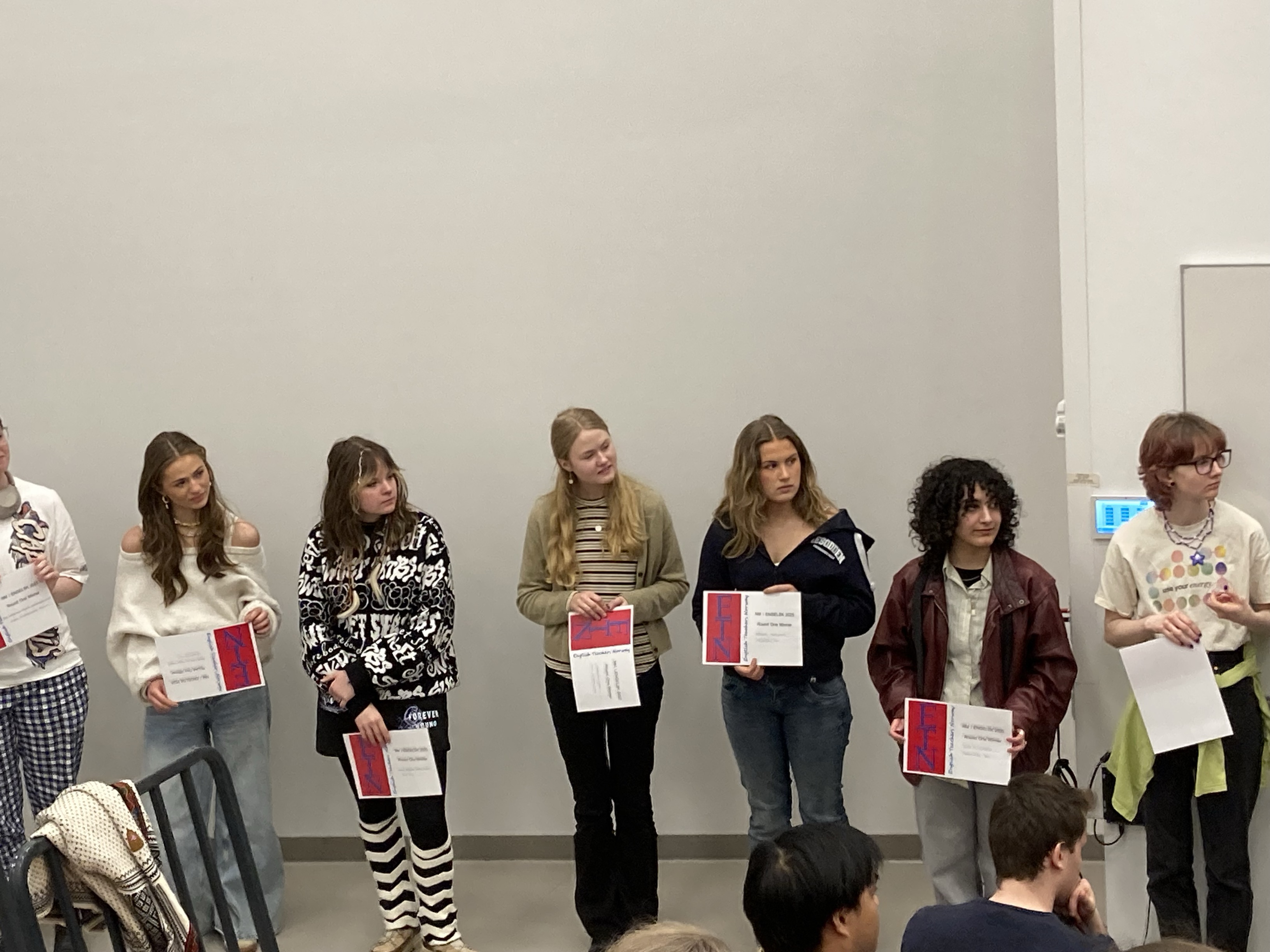 en gruppe mennesker som holder papirer