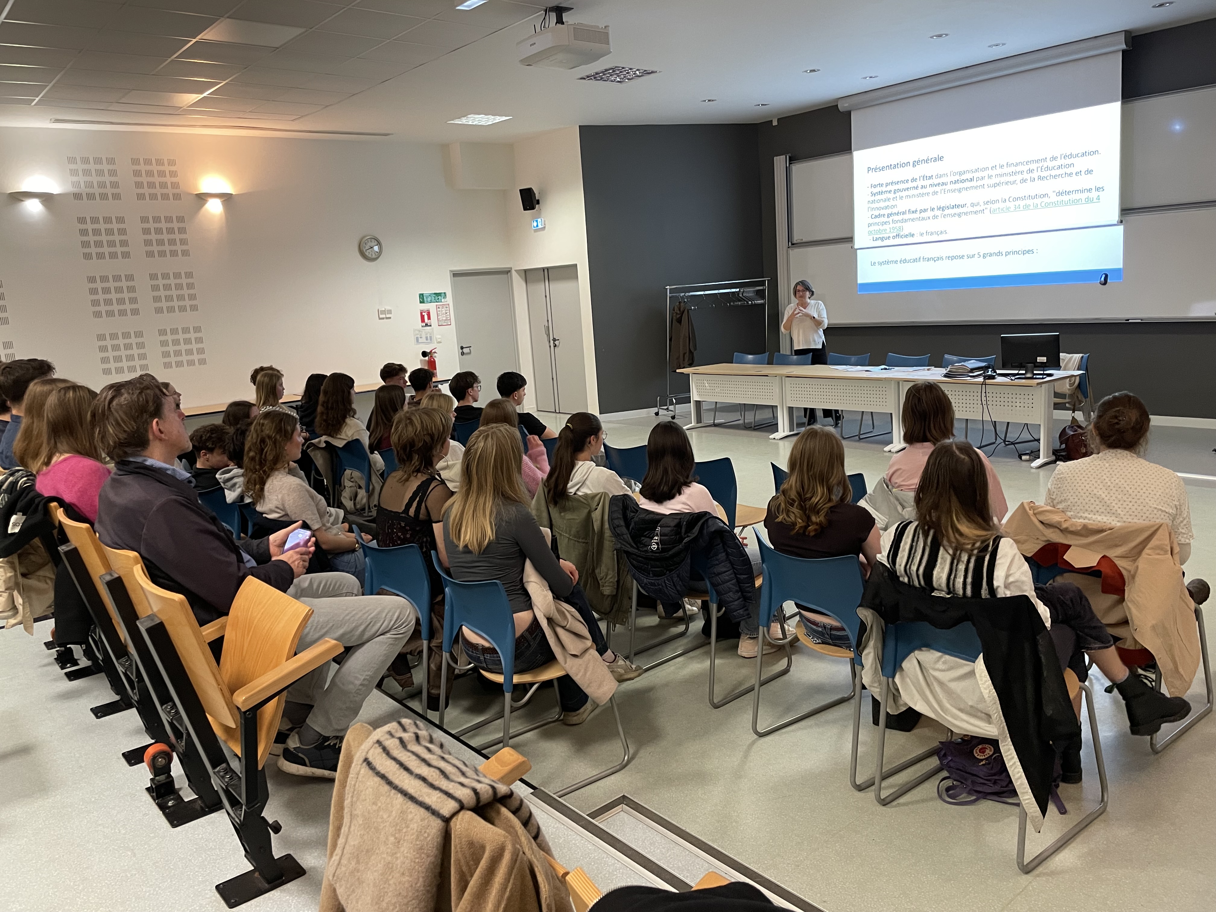 en gruppe mennesker som sitter i et rom og ser på en presentasjon